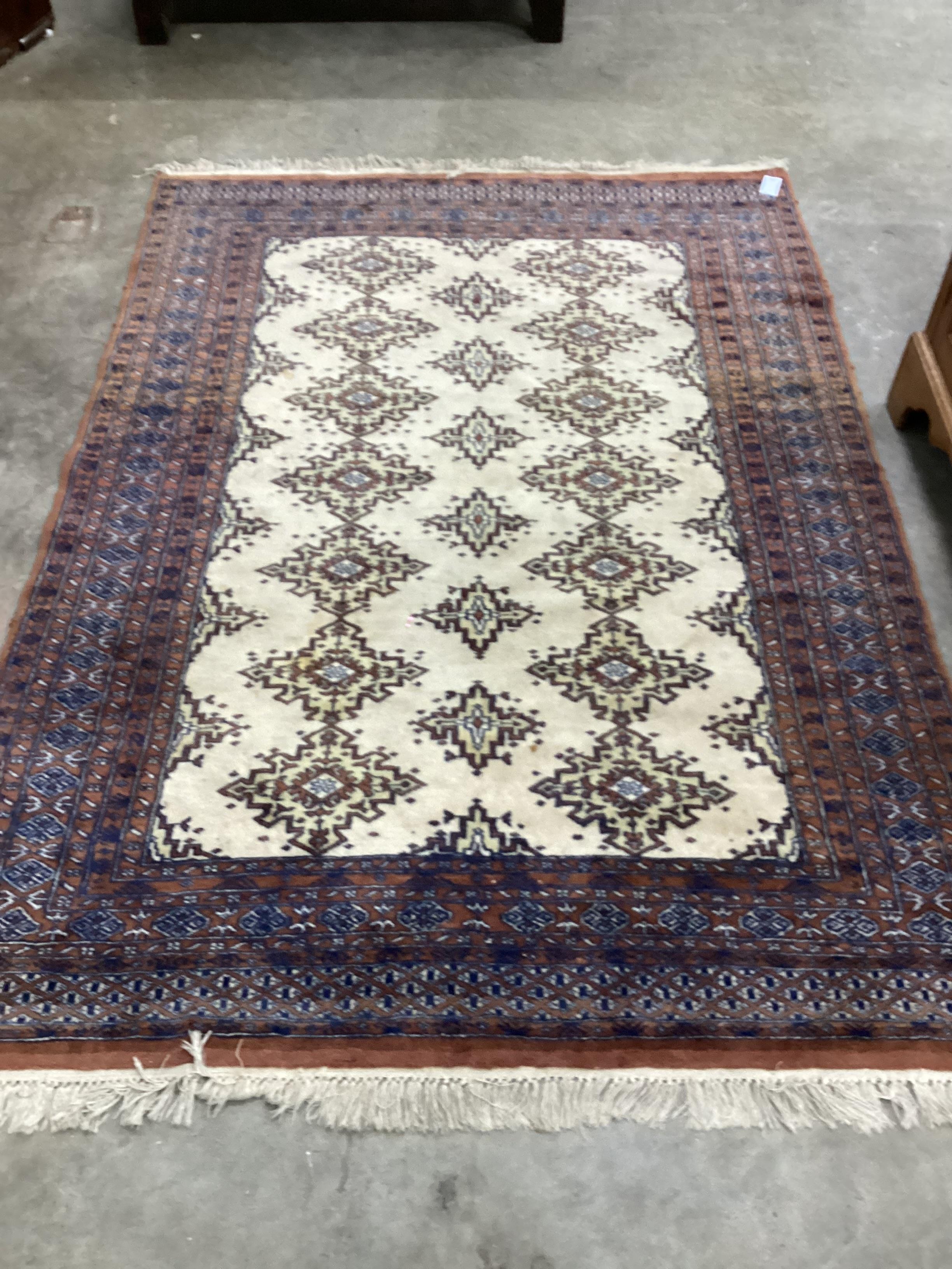 A Bokhara ivory ground rug, 200 x 142cm